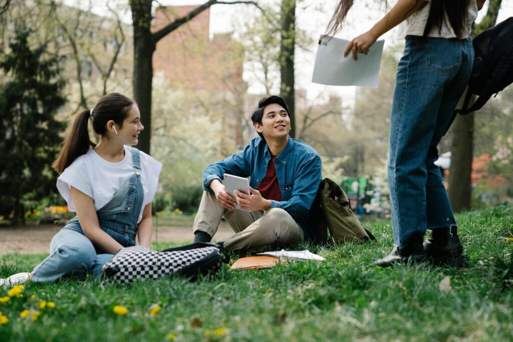 College students handing out in a park.