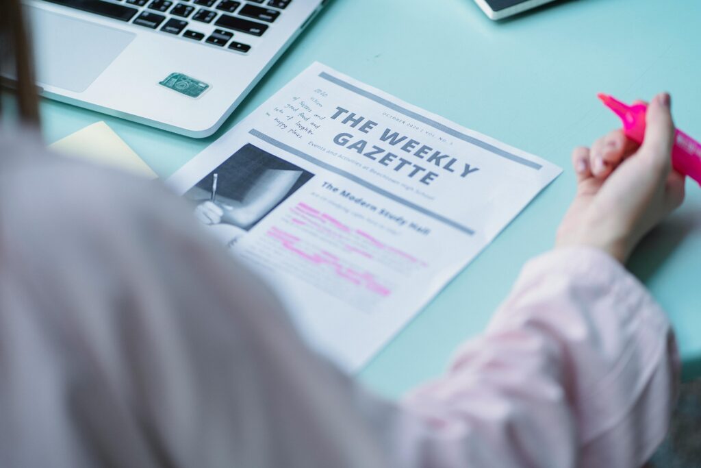 A student reading an article on paper at a table